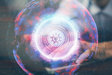 Technology theme hologram with man working on computer on background. High tech concept. Multi exposure.