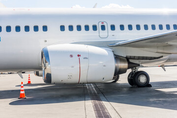 Aircraft engine, wing, landing gear and fuselage with portholes.