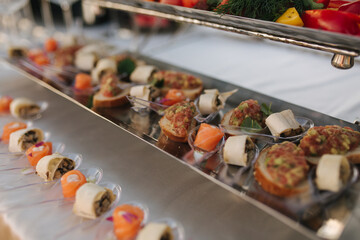 Different luzury snacks and antipasto on party. Gig table with snack outdoors