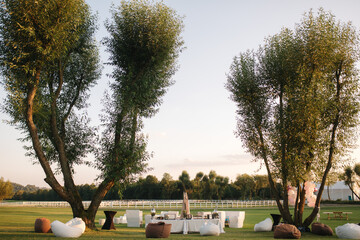 Outdoors party in cuntryside. Table with snacks in sunset