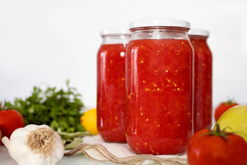 Fototapeta na wymiar Canned tomato sauce, prepared at home. Harvesting for the winter.