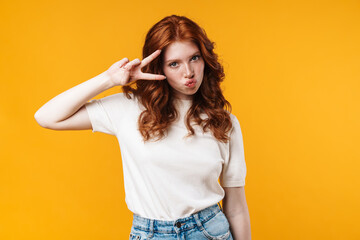 Image of ginger nice girl making kiss lips and gesturing peace sign
