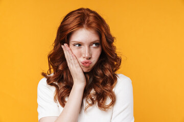 Image of ginger unhappy girl with toothache posing on camera
