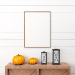 One wooden halloween frames on a white wall, with a drawer with two pumpkins and black lanterns