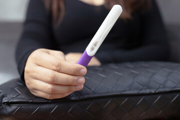 A woman using a pregnancy kit test