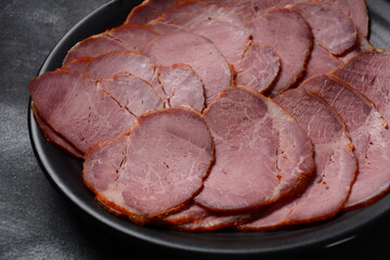 Smoked sliced beef  on black plate