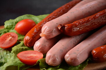 Raw  sausages with tomatoes for barbecue. 