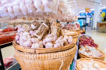 Ripe white garlic whole in a dry peel. Spicy spice fresh garlic background, healthy vegetable garlic. A large pile of garlic in basket at supermarket.