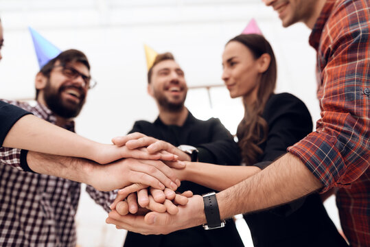 People folded their hands together as a team.