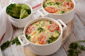 Broccoli, cheese and  egg casserole in baking cocottes