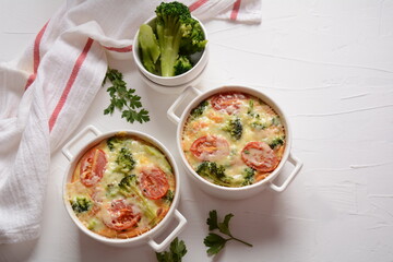 Broccoli, cheese and  egg casserole in baking cocottes