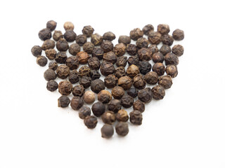 Black pepper hearts, herbs, spices in top view.