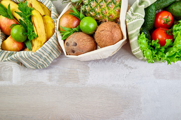 Flat lay of eco friendly grocery shopping cotton bags with organic fruits and vegetable