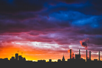Obraz premium Moscow city silhouette over dramatic cloudy sky at sunset