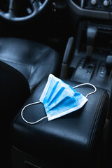 Face surgical protection mask in a car - virus covid 19
