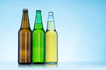 Group of Three bottles of beer on blue background