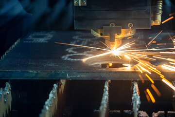 Fototapeta na wymiar Close-up scene of gas cutting machine cutting the metal plate. The hi-technology sheet metal manufacturing process by laser cutting machine.