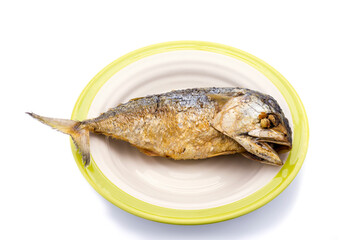 One fried mackerel in a ceramic plate on white background.