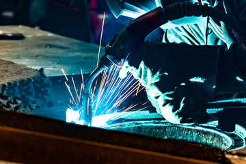 Welding work in an electromechanical workshop at a mechanical assembly site.
