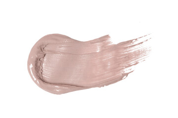 Creamy beige makeup or cosmetic product smeared on white	