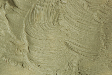 Fototapeta na wymiar Green natural cosmetic face mud, textured background. Green clay face mask, close up 