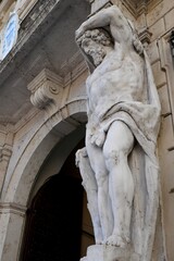 Obraz premium Telamon Statue at the entrance to the 18th century Palazzo Vescovile (Bishops Palace) in the historical center of Mantua