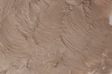 Brown natural cosmetic face mud, textured background. Red clay face mask, close up	