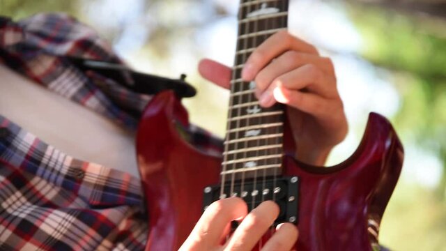 Professional guitarist practicing song with electric guitar