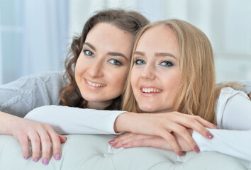 Beautiful young women hugging and looking at camera, friendship concept