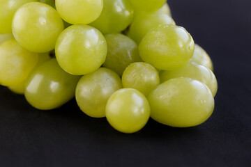 Bunch of green grapes isolated on the black background