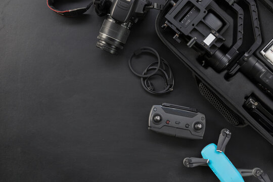 top view of work space photographer with digital camera and accessory on black background with copy space. flat lay