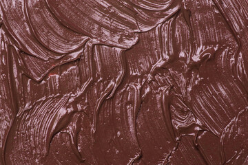 Brown natural cosmetic face mud, textured background. Red clay face mask, close up	