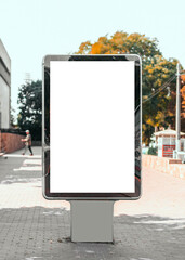 Empty mock-up of a vertical billboard street poster in the background of the city