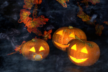 Halloween pumpkins with glowing eyes with smoke and fog