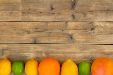 Wooden background with citrus fruits