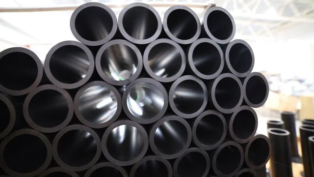 Light comes through the black plastic tubes in the manufacturing warehouse