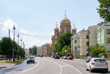 Orthodox Church in the city, cars driving along the road on a Sunny day, St. Petersburg
