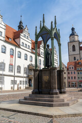 the historic market square in Wittenberg with the Luther memorial and the city hall building