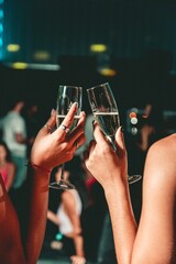 2 drinks making toasts in a nightclub