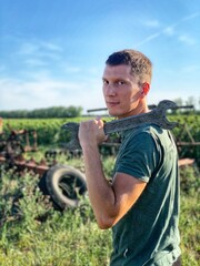 Young smiling handsome man with wrench outdoor