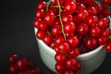 A ceramic bowl with red currant berries	