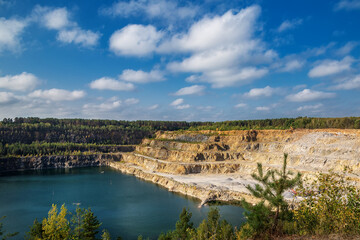 Abandoned granite and sand quarry with a lake. Stone extraction in the canyon.