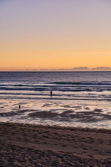 Rod fisherman in the beach of Mar de Fora, Finisterre, Galicia, Spain. This beach is the westernmost beach in Europe, so people go there to see one of the most impressive sunsets in Northern Spain