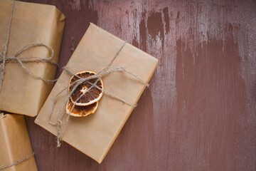 brown and frosty christmas background with stylishly wrapped gifts