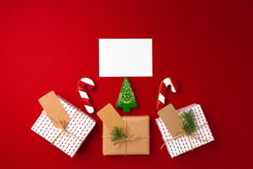 Christmas gift and gingerbread cookies on red background