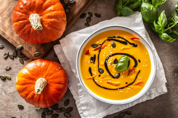 Homemade pumpkin soup in bowles with. Autumn hokkaido soup with balsamic vinegar - obrazy, fototapety, plakaty