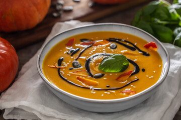 Homemade pumpkin soup in bowles with. Autumn hokkaido soup with balsamic vinegar