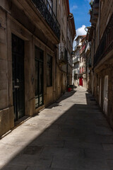 Fototapeta na wymiar Narrow Alley With Shadows In Ponte De Lima, Portugal