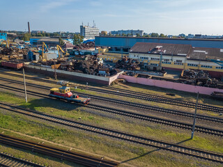 Industrial scene with trains, railway platform, Metalworking plant, top view from a drone. Freight train. The carriages of goods by rail. Heavy industry.