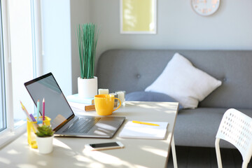 Workplace with modern laptop in the interior of the room